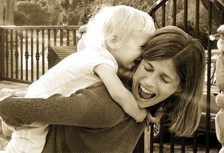 happy woman carrying a baby on her back 